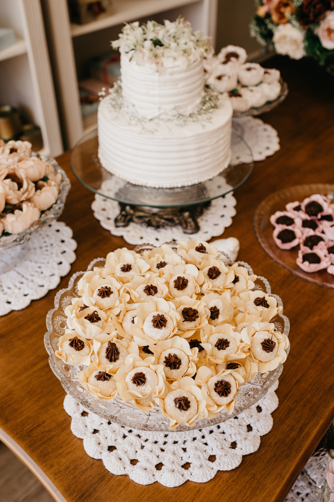 Wedding cake and delicious biscuits on table indoors